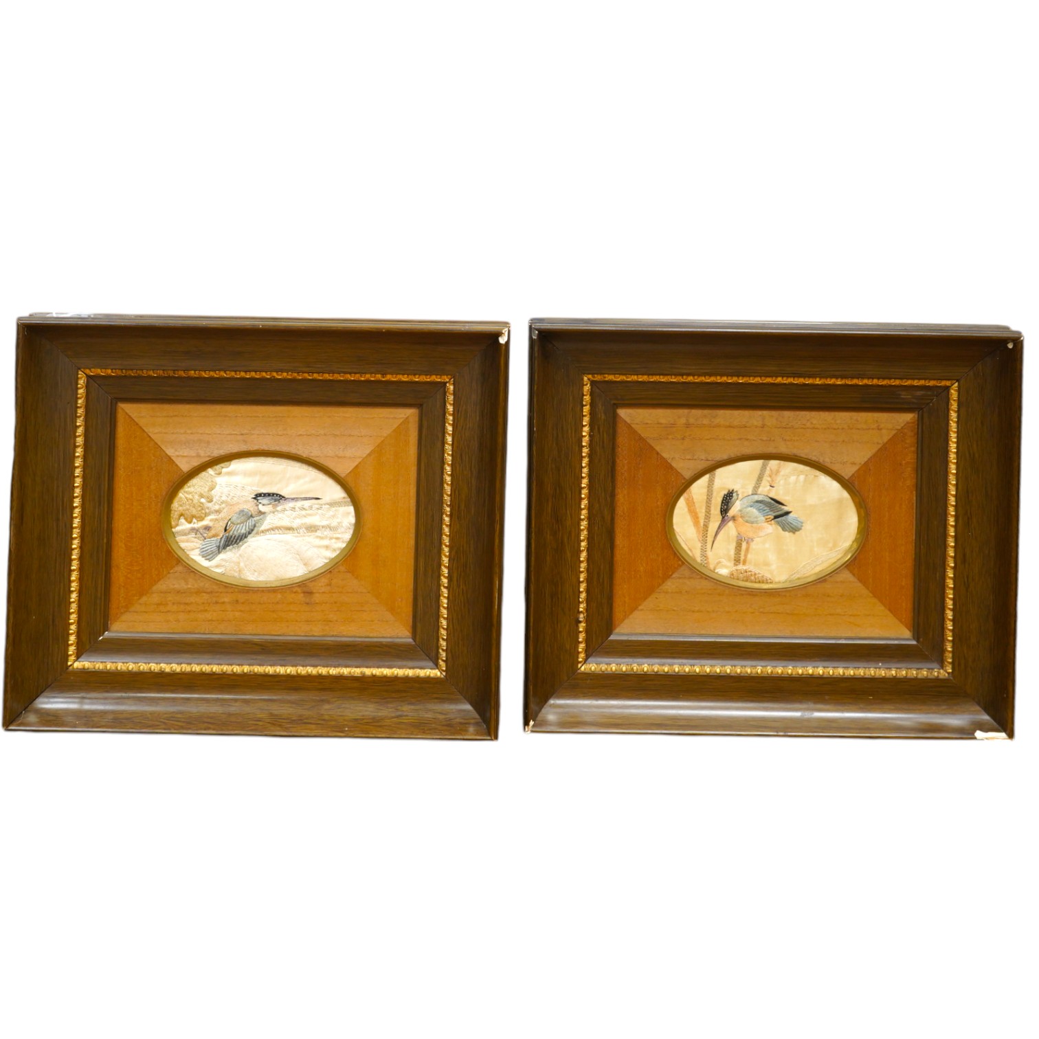 A pair of framed early 20th century Japanese oval silk embroideries of Kingfishers, embroidered on cream silk in pastel shades of silk thread, in a variety of stitches, various parts of each bird slightly couched giving